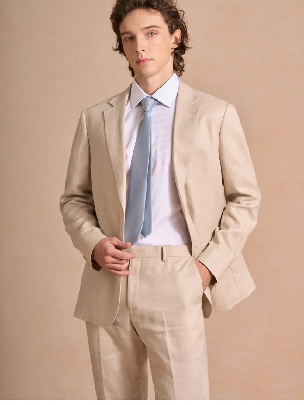 Men’s beige suit jacket with vest and tie all from azazie.